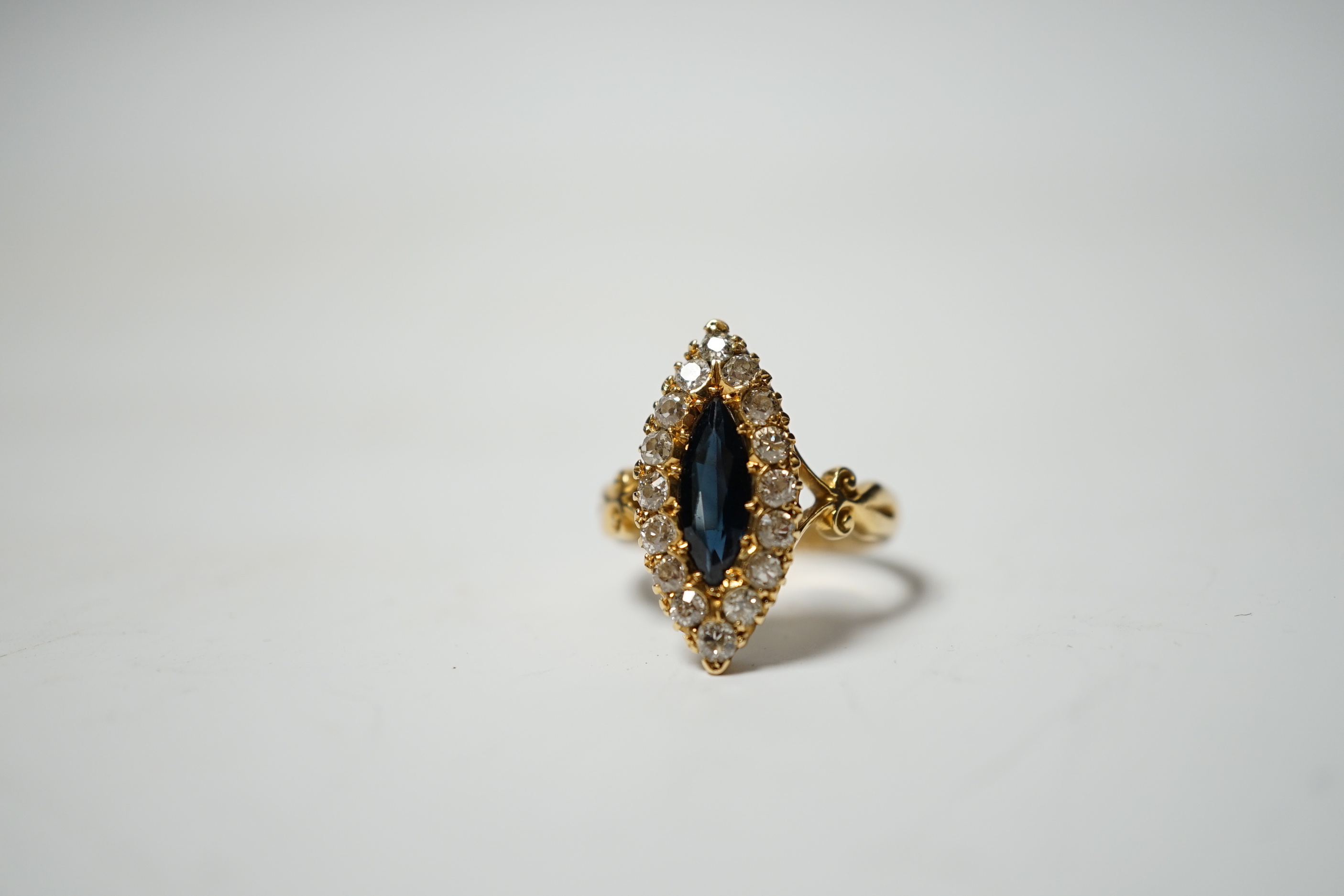 An Edwardian 18ct gold, sapphire and diamond cluster set marquise shaped ring, size K, gross weight 4.2 grams.